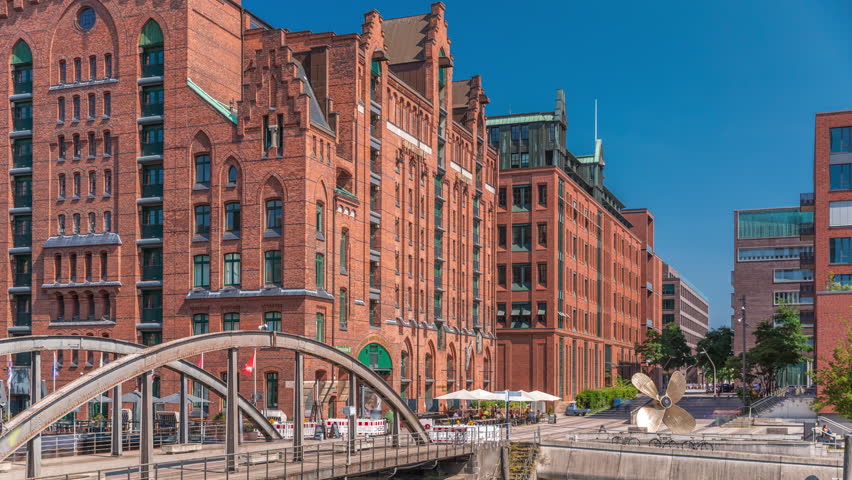 Famous old Speicherstadt in Hamburg timelapse featuring the International Maritime Museum, iconic brick buildings, arch bridges, canals and waterfront. A historic landmark in Germany