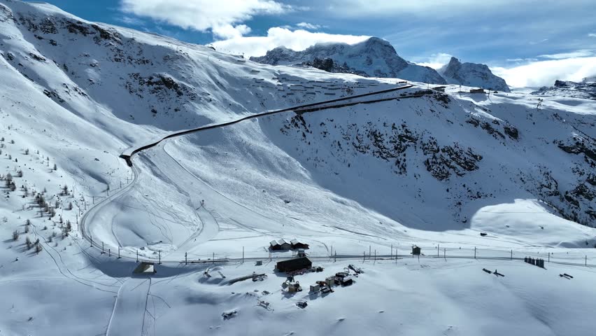 Zermatt Gornergrat Railway train at Riffelberg, Riffelalp heading up the view point during a sunny afternoon with a blue sky and the Matterhorn during Winter in Switzerland