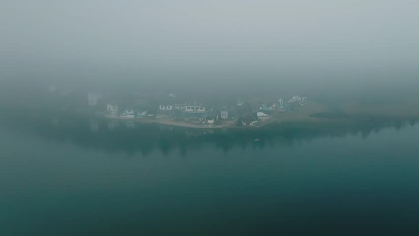 Aerial Drone Footage of Village and Lake in the Clouds – 4K