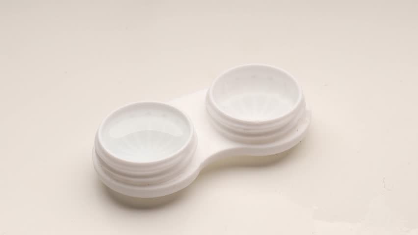 Removing a Contact Lens from a Lens Case. Eye Care and Hygiene Concept.