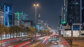 Cityscape aerial night timelapse of Riyadh, Saudi Arabia, featuring illuminated towers, glass skyscrapers, King Fahd Road and busy traffic. Palms and streetlights line the main highway through city. - Powered by Shutterstock - Get 15% off with code: PIKWIZARD15