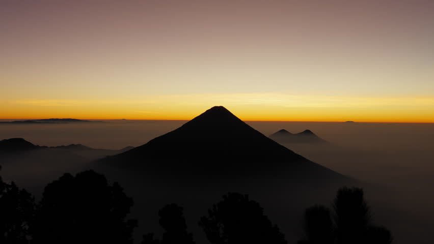 Breathtaking sunrise footage of Agua Volcano, filmed from Acatenango. Ideal for documentaries, travel videos, and projects seeking stunning natural landscapes. Static shot