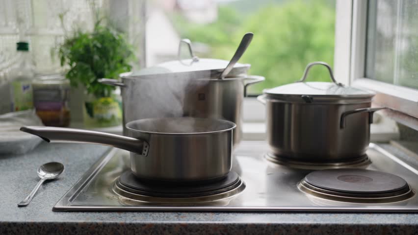 Cooking Pots On a Stove Creating Steam Inside A Bright and Inviting Kitchen Space