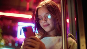 Caucasian Asian girl teenager junior use mobile phone in city schoolgirl kid chat social media daughter typing cellphone child Internet night The inscription noodle in Chinese. Translation: 'noodle'.  - Powered by Shutterstock - Get 15% off with code: PIKWIZARD15