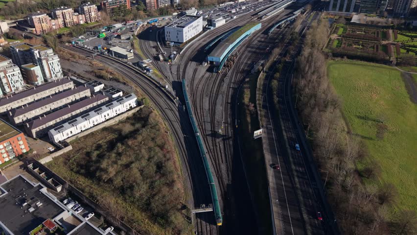 Dublin train station aerial, railway tracks, urban buildings, and green park view