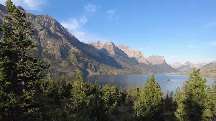 Sunrise panning of St. Mary Lake and Wild Goose Island in Glacier National Park, Montana with Fusillade, Gunsight, Dusty Star, Little Chief and Mahtotopa Mountains in the background.