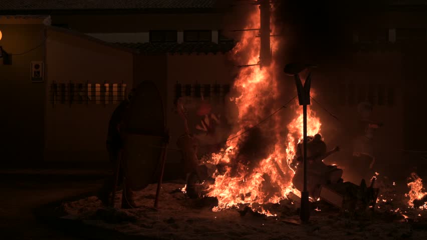 Firefighter assisting in the burning of a Fallas monument in Valencia