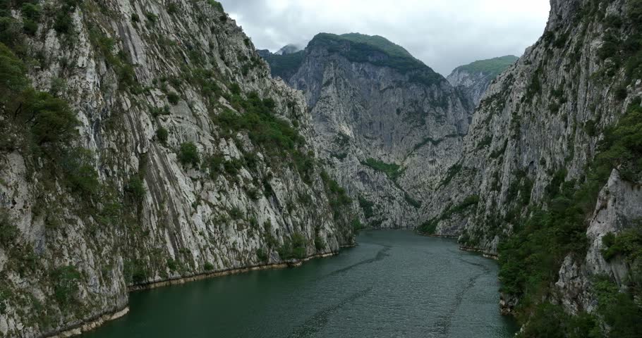 Komani Lake Surrounded By Towering Mountains Of The Albanian Alps In Kukes, Albania. drone pullback shot