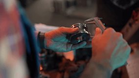 Skilled manufacturing worker carefully measuring precision metal component using caliper during quality control inspection in industrial workshop - Powered by Shutterstock - Get 15% off with code: PIKWIZARD15