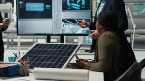 Management executives and investors in photovoltaics plant analyzing market trends to determine investment strategies for expanding solar energy production capabilities, camera B - Powered by Shutterstock - Get 15% off with code: PIKWIZARD15