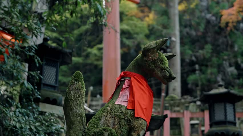 A stone dog statue stands at the entrance of Fushimi Inari Shrine in Kyoto, Japan, adding to the spiritual atmosphere of this sacred site.