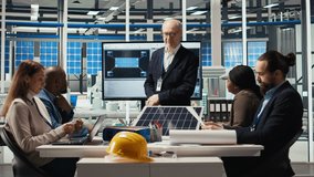 Businessmen in photovoltaics factory doing financial investments in sustainable manufacturing sector. Executives meet to discuss automation strategies for solar panel production scaling, camera A - Powered by Shutterstock - Get 15% off with code: PIKWIZARD15