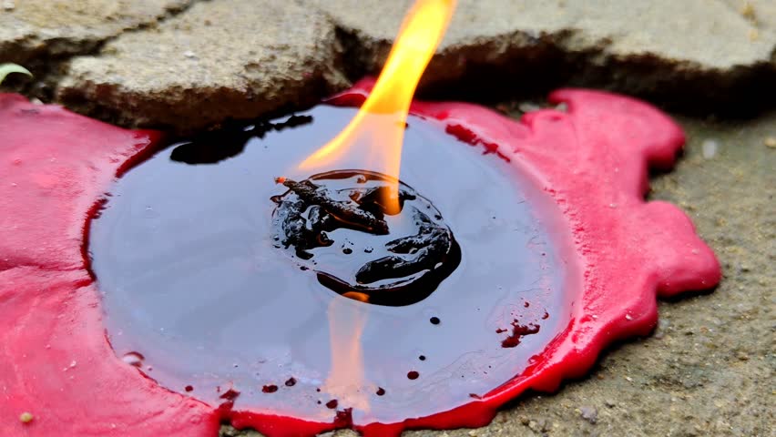 Melted red candle with smoldering flame on cement surface - Powered by Shutterstock - Get 15% off with code: PIKWIZARD15