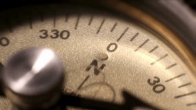 Closeup on a compass pointing direction. Old compass. Macro shot, shallow focus. Travel, geography, navigation, tourism and exploration concept background. Closeup of compass navigation tool. - Powered by Shutterstock - Get 15% off with code: PIKWIZARD15