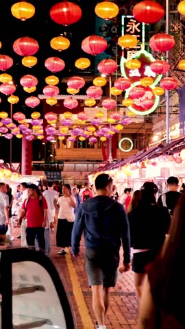 Colorful lanterns illuminate bustling market street