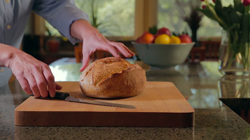 Woman slides sourdough bread