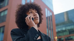 Businesswoman on phone call holding notepad - Powered by Shutterstock - Get 15% off with code: PIKWIZARD15