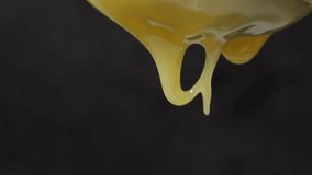 Extreme close up of honey dripping from a small spoon. Focus on the droplets falling down. Food close up and macro footage.  - Powered by Shutterstock - Get 15% off with code: PIKWIZARD15