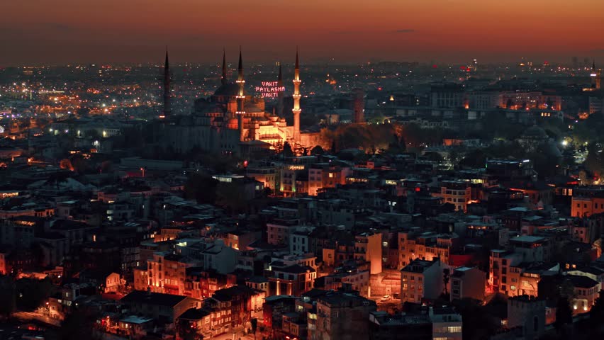 Breathtaking sunset in Istanbul highlights Hagia Sophia lit up against twilight. Cityscape glows with vibrant lights, creating romantic atmosphere. Perfect for travel lovers.