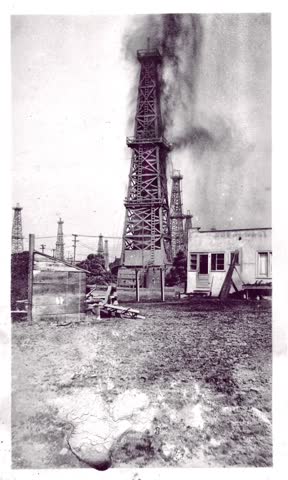 Suburban Industrial Snapshot of Signal Hill CA 1895-1910 pressurized oil shooting into the air above an oil well.