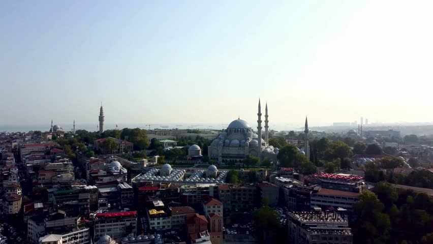 Dramatic aerial perspective of Istanbul featuring diverse cityscape and magnificent architecture. Golden hour light enhances historic mosques and modern buildings.