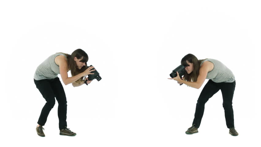 Two girls filming different angles of an unseen object in a white studio..