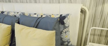 Cozy bedroom setup with colorful cushions and modern decor in a stylish interior space - Powered by Shutterstock - Get 15% off with code: PIKWIZARD15