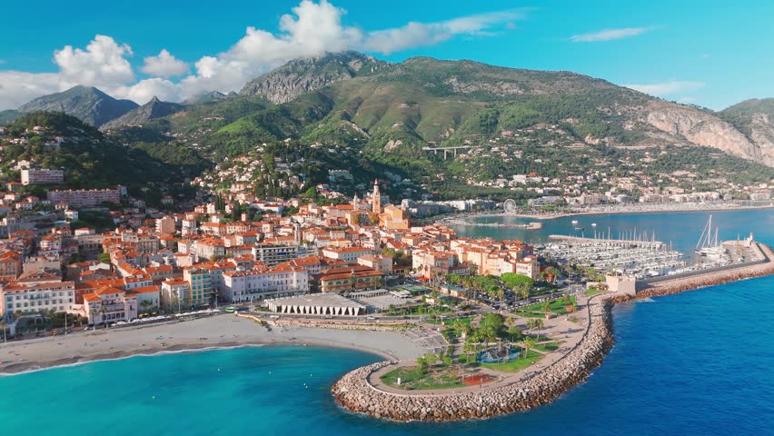 Aerial view of Menton, a resort town on the French Riviera, France. The colourful old town of Menton in summer, with historic buildings and beautiful beach at sunset on the Cote dAzur.