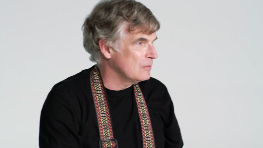 Male photographer frames various shots with his hands and smiles.