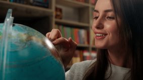 Caucasian woman spinning globe model earth geography lesson study learning choosing country travel tour trip dreaming female girl businesswoman vacation business student tourist teacher indoor library - Powered by Shutterstock - Get 15% off with code: PIKWIZARD15