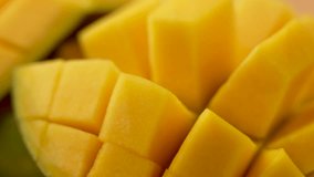A close up of a yellow mango with the skin removed. The mango is sliced into small pieces - Powered by Shutterstock - Get 15% off with code: PIKWIZARD15
