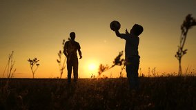 Happy active family play ball. Father throwing ball to child son in summer park, educational game having fun nature. Father son playing ball at sunset summer meadow, slow motion. Dad together with son - Powered by Shutterstock - Get 15% off with code: PIKWIZARD15