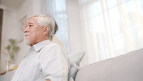 Happy Asian family senior couple enjoy watching movie together on smart TV in living room. Elderly retired husband and wife relaxing at home. Aged people mental healthcare and smart life technology. - Powered by Shutterstock - Get 15% off with code: PIKWIZARD15