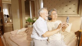 Happy Asian family senior couple video call on smartphone webcam mobile app with child and grandchild at home. People virtual communication wireless technology connection with using digital gadget. - Powered by Shutterstock - Get 15% off with code: PIKWIZARD15