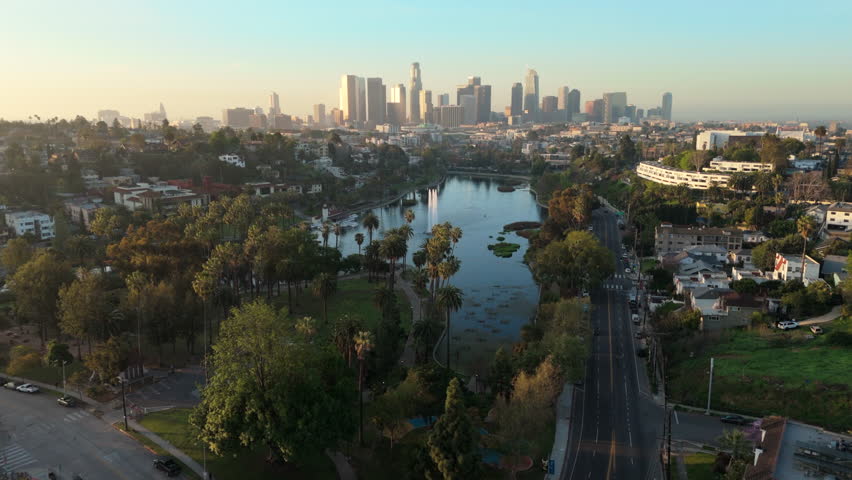 Breathtaking aerial drone footage captured in the morning light of Echo Park Lake highlights the stunning beauty and vibrant landscape of downtown Los Angeles skyline, California, in all its glory