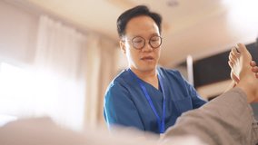 Asian senior man patient doing rehab physical therapy stretching muscle leg and knee with physiotherapist caregiver on bed in bedroom. Home medical caregiving services and elderly people healthcare. - Powered by Shutterstock - Get 15% off with code: PIKWIZARD15