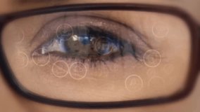 Animation overlaying digital world map and data icons on person's eye with glasses. Technology, innovation, futuristic, analytics, vision, connectivity - Powered by Shutterstock - Get 15% off with code: PIKWIZARD15