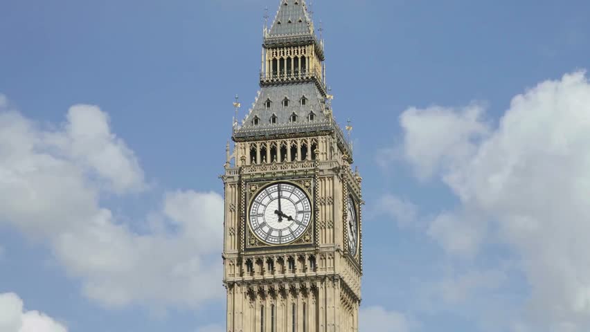 Iconic Big Ben clock tower showcases intricate design and architecture. Beautifully illuminated under bright sunlight, capturing attention of visitors in London.