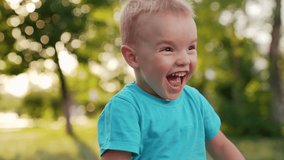 Happy boy child laughs runs in city park in summer. Concept of happy childhood, family. Little boy plays on street, happy emotions, laughter joy. Slow motion. Active child plays with parents in park - Powered by Shutterstock - Get 15% off with code: PIKWIZARD15