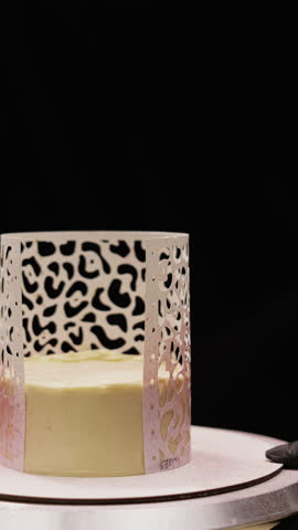 Confectioner Decorating Cake with Airbrush and Stencil in Bakery