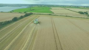 Combine harvester working in wheat field with digital data overlay animation. Agriculture, farming, technology, innovation, analytics, machinery - Powered by Shutterstock - Get 15% off with code: PIKWIZARD15