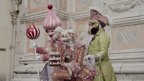 Venice, Italy - People dressed in carnival masks are photographed by tourists in the scenery of the ancient Venetian palaces - Powered by Shutterstock - Get 15% off with code: PIKWIZARD15
