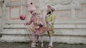 Venice, Italy - People dressed in carnival masks are photographed by tourists in the scenery of the ancient Venetian palaces - Powered by Shutterstock - Get 15% off with code: PIKWIZARD15