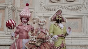 Venice, Italy - People dressed in carnival masks are photographed by tourists in the scenery of the ancient Venetian palaces - Powered by Shutterstock - Get 15% off with code: PIKWIZARD15