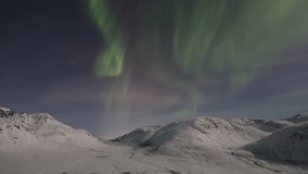 Northern Lights Aurora dancing above a snow covered valley close to Tromsø, Northern Norway.  - Powered by Shutterstock - Get 15% off with code: PIKWIZARD15