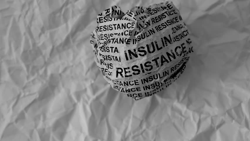 Crumpled paper ball with words Insulin Resistance on a crumpled white paper background.