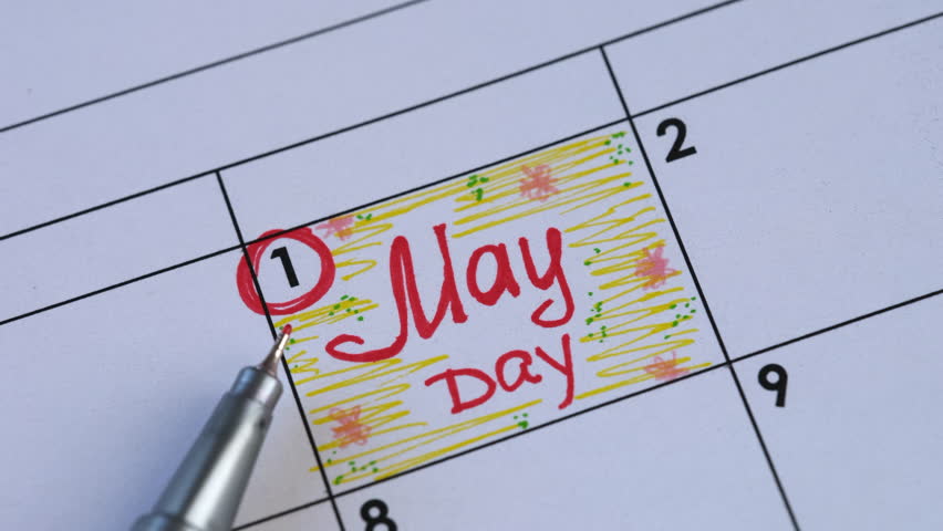 Paper calendar with handwritten reminder May Day on it and a red pen. May 01.