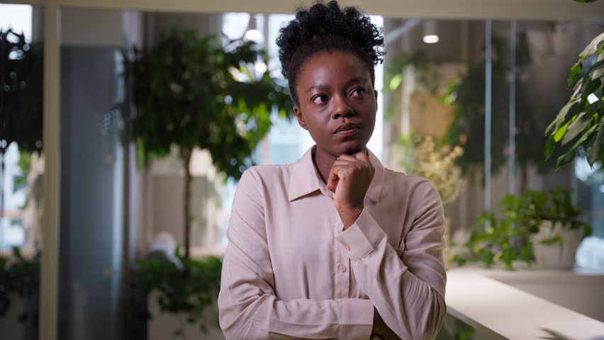 Thinking woman African American ethnic thoughtful girl businesswoman in office pensive consider female manager business employer think idea planning search solution problem doubt question dream ponder