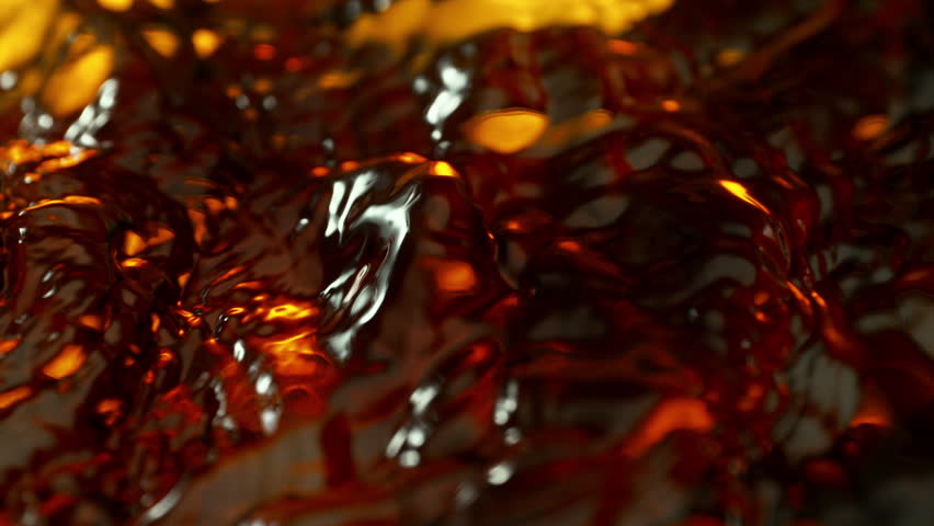 Super Slow Motion Detail Shot of Waving Golden Liquid at 1000fps.