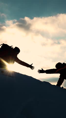 Go towards your goal. Travelers climb one after another on rock Climbers silhouettes stretch their hands to each other climbing to top of hill. Teamwork of business people. Team of businessmen victory